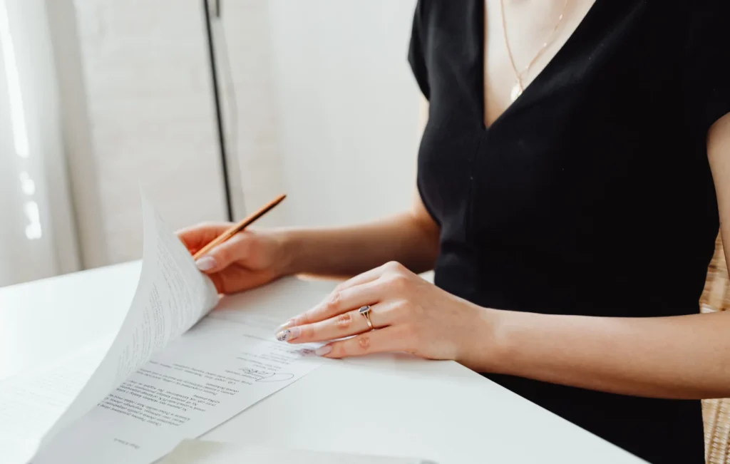 mental health group practice owner sitting at desk with forms and a pen