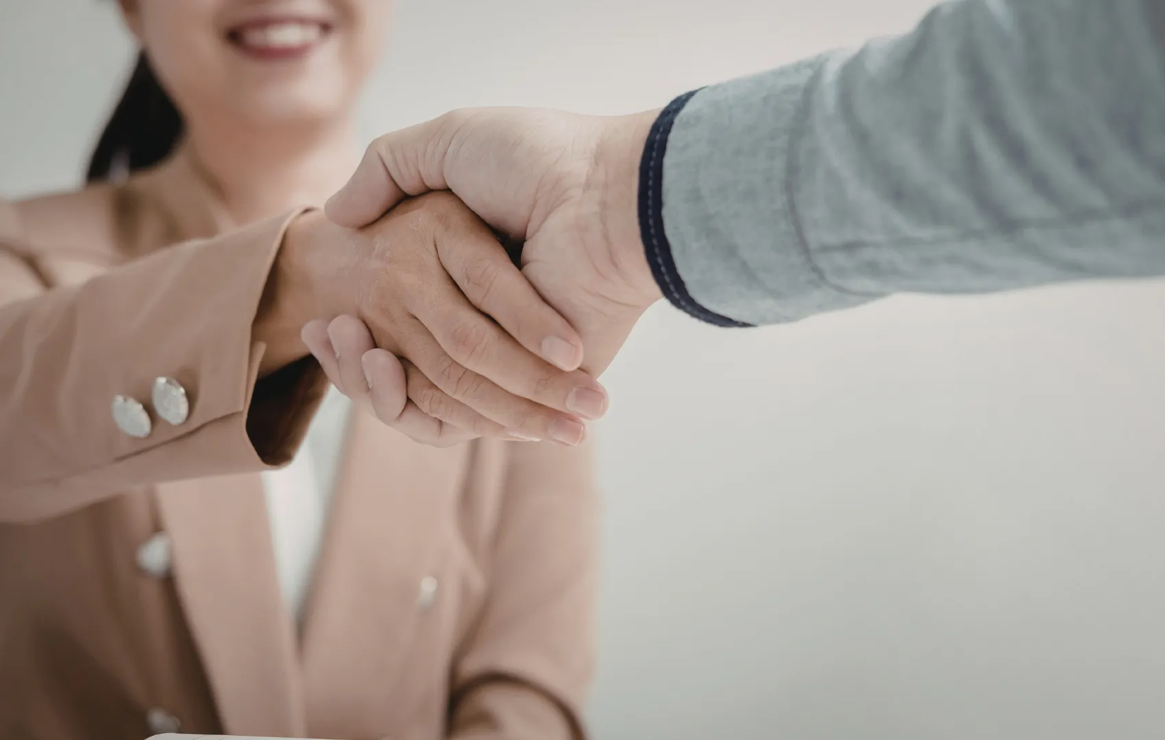 Buyer and seller shaking hands when greeting each other to discuss a mental health group practice sell